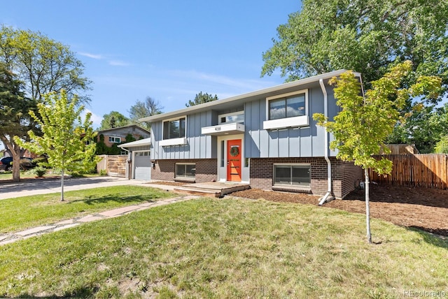 4381 Dixon Dr, Westminster, CO 80031 - split foyer home featuring board and batten siding, brick siding, a garage, and concrete driveway