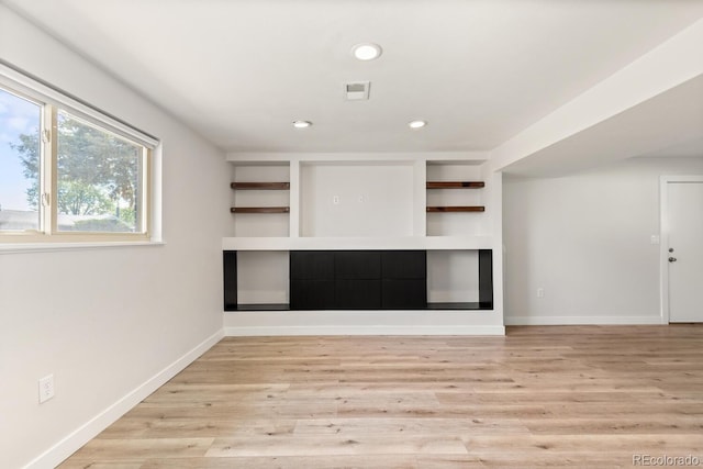 4381 Dixon Dr, Westminster, CO 80031 - unfurnished living room with recessed lighting, light wood-style flooring, baseboards, and built in shelves