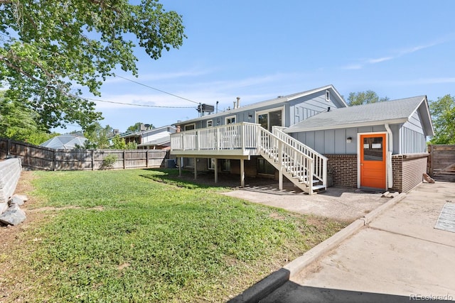4381 Dixon Dr, Westminster, CO 80031 - rear view of house with stairway, a wooden deck, brick siding, board and batten siding, and an outbuilding