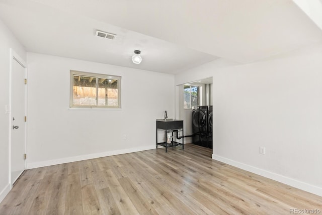 4381 Dixon Dr, Westminster, CO 80031 - spare room featuring independent washer and dryer, light wood-style flooring, and baseboards