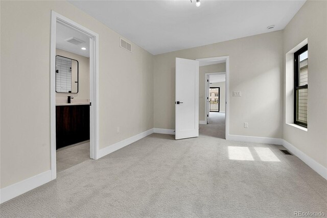 2162 S Ash St, Denver, CO 80222 - empty room featuring light carpet, baseboards, and a sink
