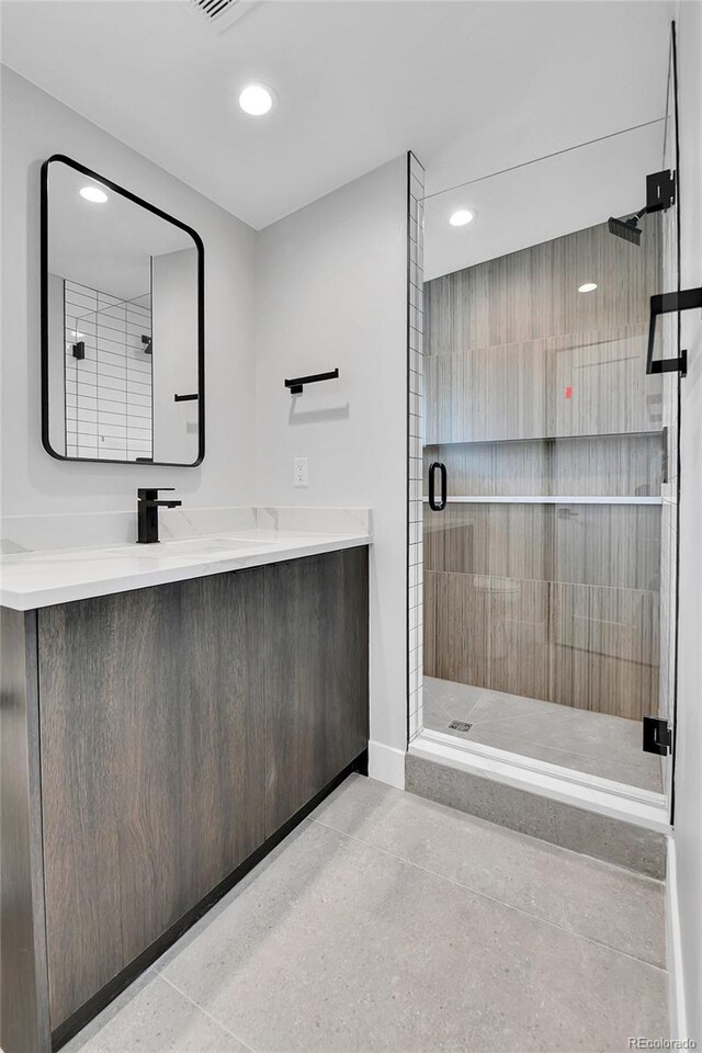 2162 S Ash St, Denver, CO 80222 - full bath featuring a shower stall, recessed lighting, baseboards, and vanity