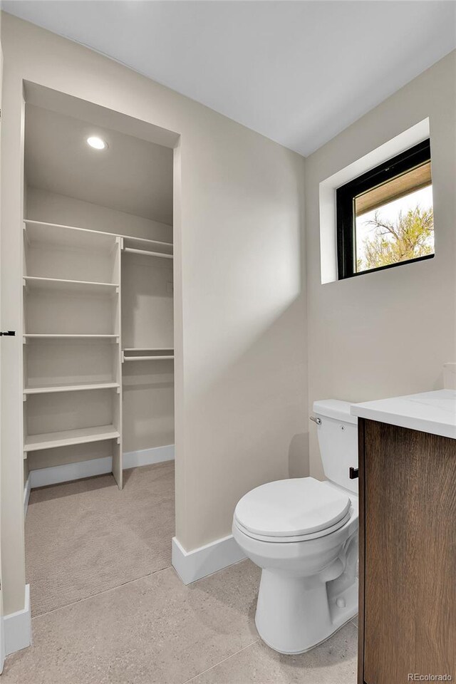 2162 S Ash St, Denver, CO 80222 - bathroom with baseboards, toilet, and vanity