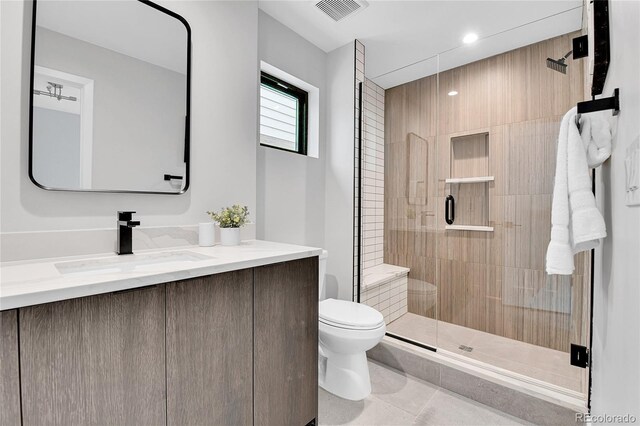 2162 S Ash St, Denver, CO 80222 - bathroom featuring toilet, a stall shower, tile patterned floors, and vanity