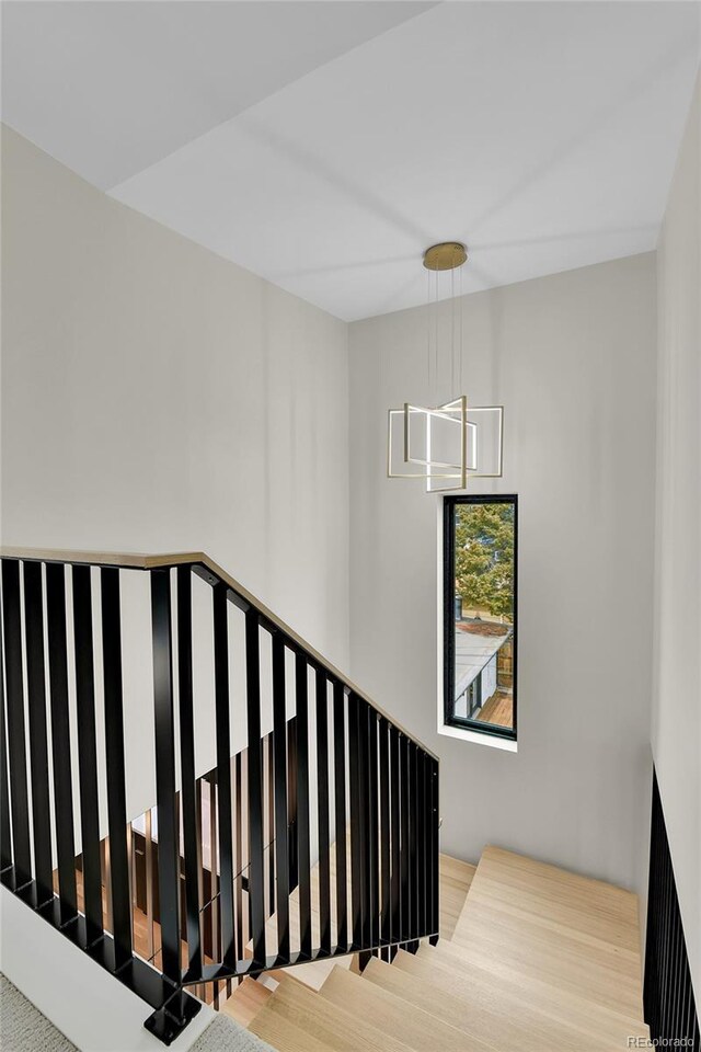 2162 S Ash St, Denver, CO 80222 - stairway with a chandelier and wood finished floors