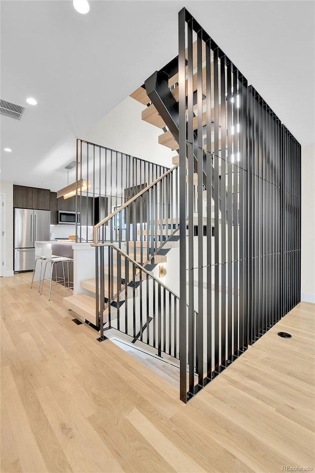 2162 S Ash St, Denver, CO 80222 - stairs featuring wood finished floors and recessed lighting