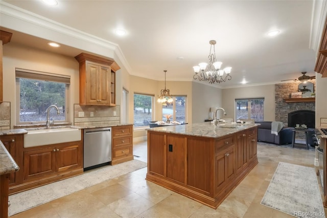 kitchen with a sink, light stone countertops, open floor plan, and dishwasher