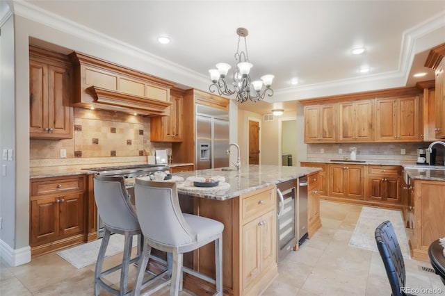 kitchen with light stone counters, appliances with stainless steel finishes, a breakfast bar, and crown molding