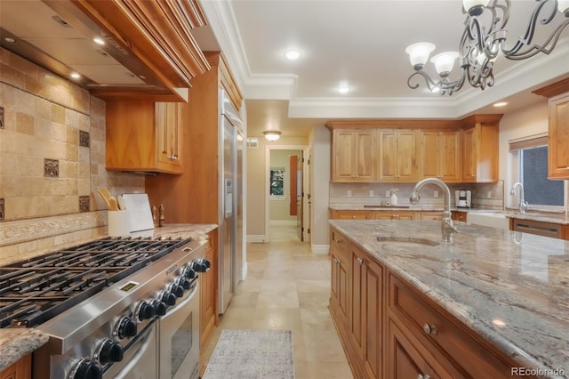 kitchen featuring high quality appliances, light stone counters, ornamental molding, custom exhaust hood, and a sink