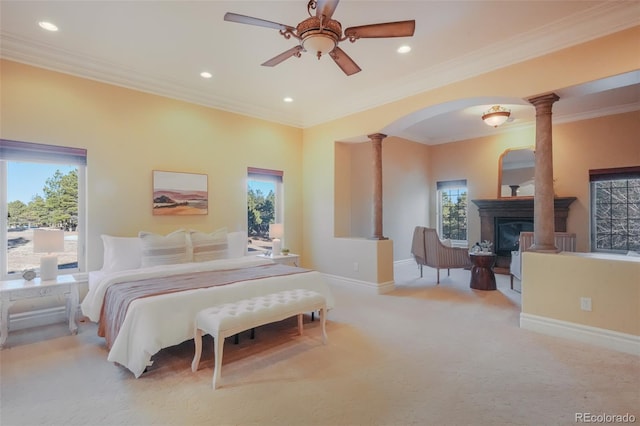 bedroom with recessed lighting, ornate columns, a glass covered fireplace, carpet flooring, and baseboards