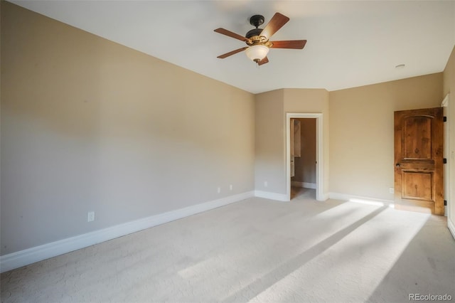 unfurnished bedroom featuring a ceiling fan, light carpet, and baseboards