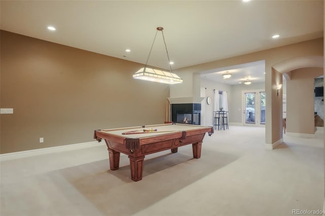 rec room with light carpet, baseboards, a multi sided fireplace, and recessed lighting