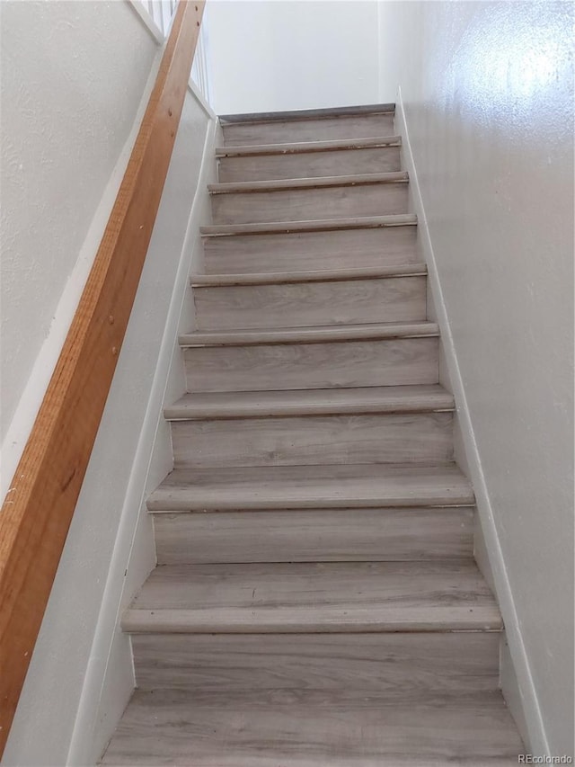 stairway featuring wood-type flooring