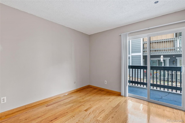 unfurnished room featuring a textured ceiling and hardwood / wood-style flooring