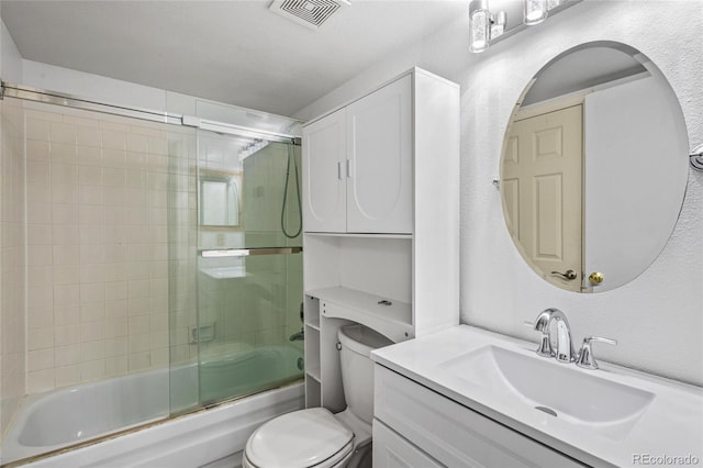 full bathroom with shower / bath combination with glass door, vanity, and toilet