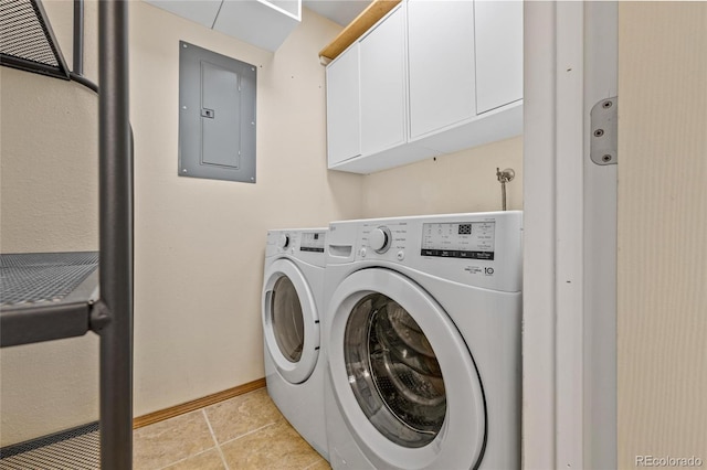 laundry area with electric panel, washer and clothes dryer, light tile patterned flooring, and cabinets