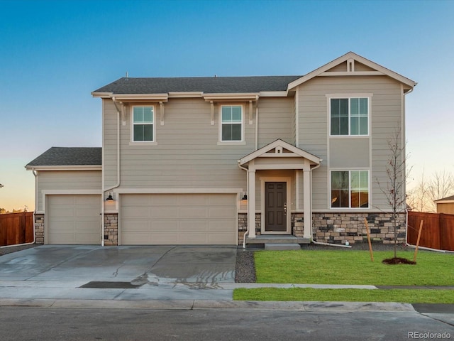 view of front facade with a yard and a garage