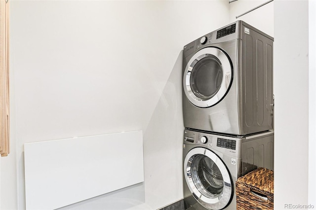 clothes washing area with stacked washer / drying machine and laundry area