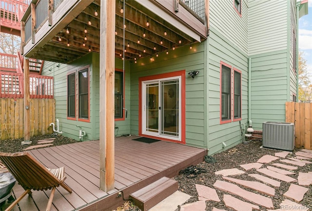 deck featuring central AC unit and fence