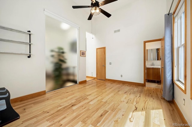 2937 Champa St Unit A, Denver, CO 80205 - unfurnished bedroom with visible vents, wood finished floors, baseboards, and a sink
