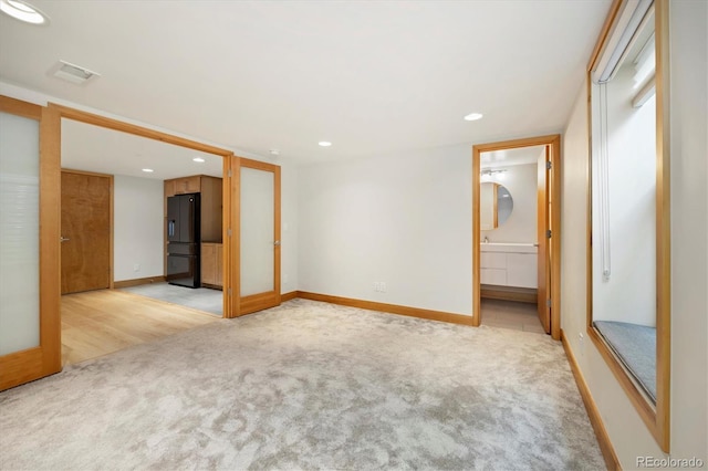 2937 Champa St Unit A, Denver, CO 80205 - unfurnished room featuring light carpet, baseboards, visible vents, and recessed lighting