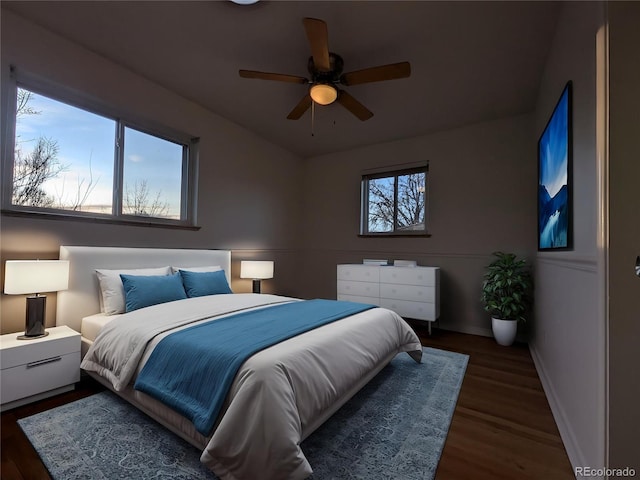 bedroom with baseboards, wood finished floors, and ceiling fan