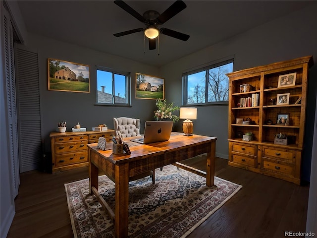 office area featuring baseboards, a ceiling fan, and dark wood-style floors