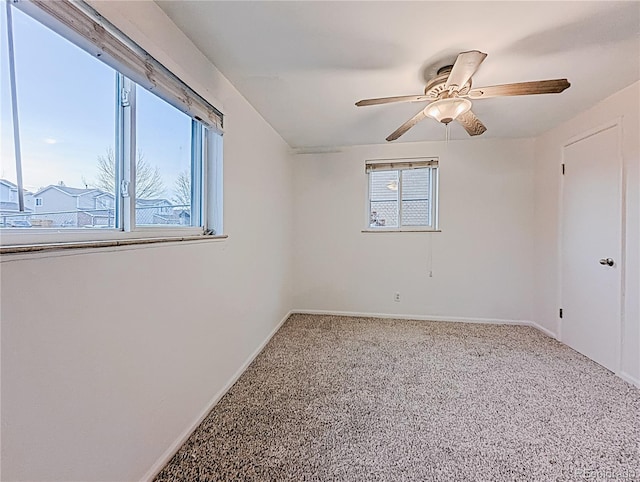 unfurnished room featuring a ceiling fan, baseboards, and carpet floors
