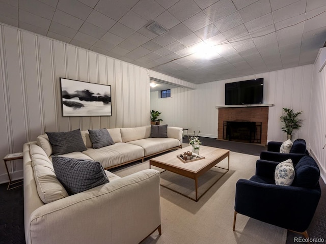 carpeted living room featuring a brick fireplace and visible vents