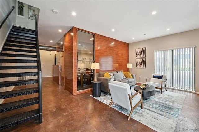 3195 Blake St Unit 106, Denver, CO 80205 - living area featuring finished concrete floors, recessed lighting, stairs, and baseboards