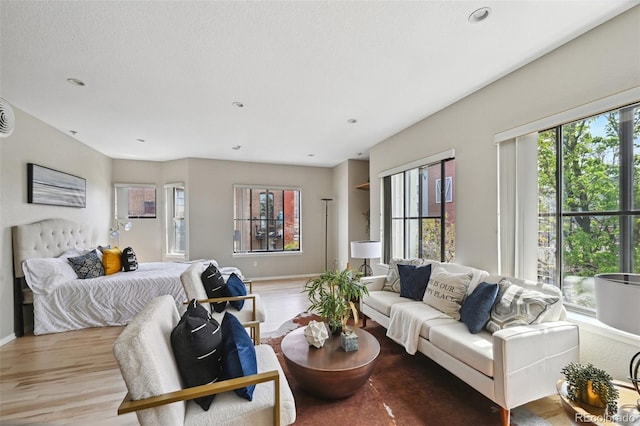 3195 Blake St Unit 106, Denver, CO 80205 - living area with light wood-style flooring, baseboards, and recessed lighting