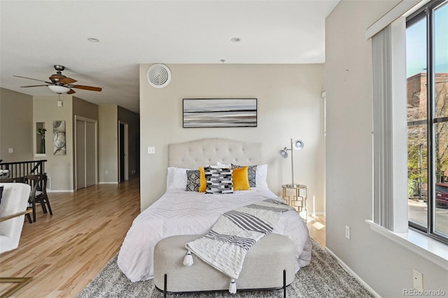3195 Blake St Unit 106, Denver, CO 80205 - bedroom featuring wood finished floors, baseboards, and access to exterior