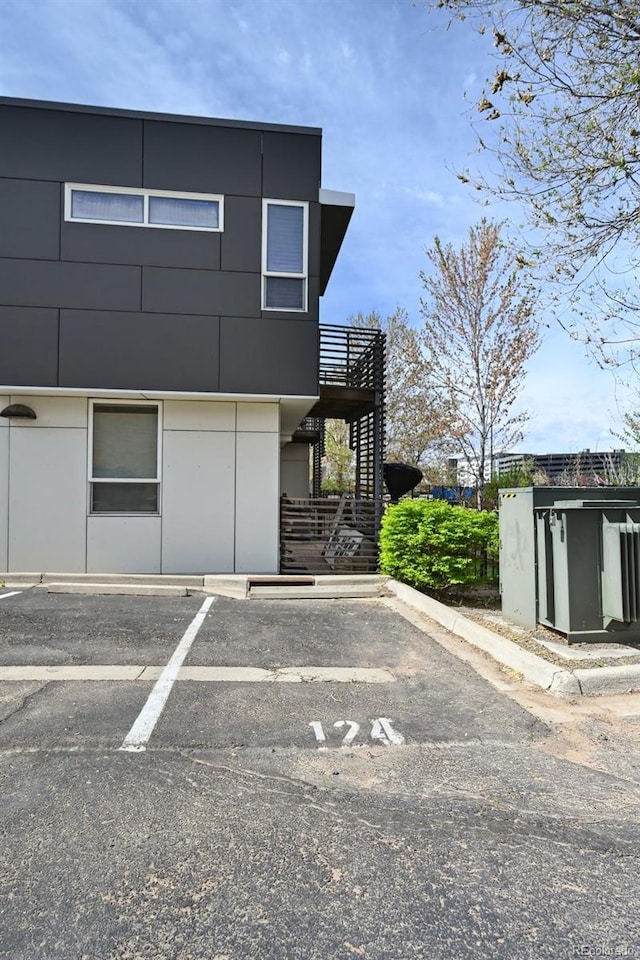 3195 Blake St Unit 106, Denver, CO 80205 - uncovered parking lot featuring stairway