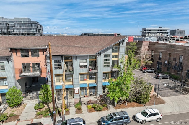 3195 Blake St Unit 106, Denver, CO 80205 - view of building exterior with uncovered parking