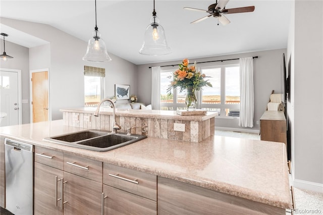 kitchen featuring sink, vaulted ceiling, stainless steel dishwasher, a kitchen island, and pendant lighting