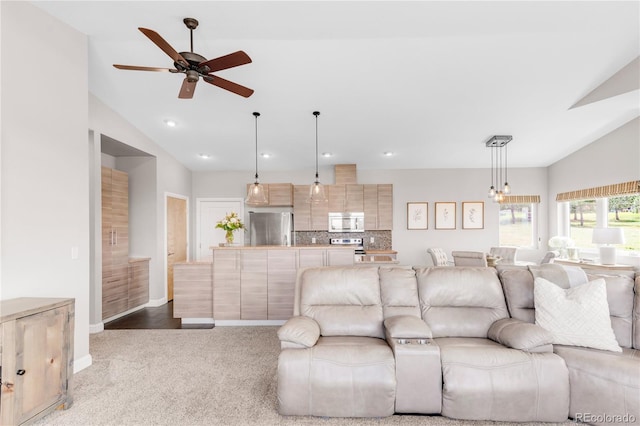 carpeted living room featuring vaulted ceiling and ceiling fan