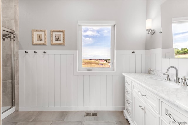 bathroom featuring vanity, tile patterned flooring, and a shower with door