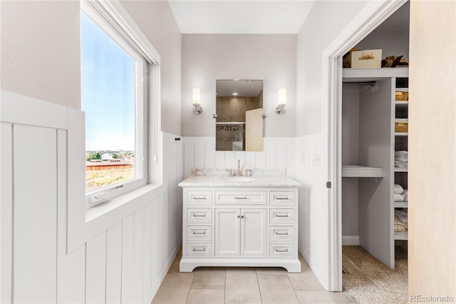 bathroom with vanity, tile patterned flooring, and walk in shower