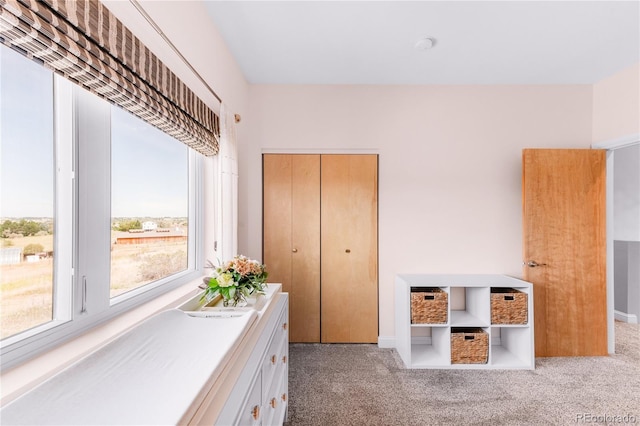 bedroom featuring light carpet and a closet