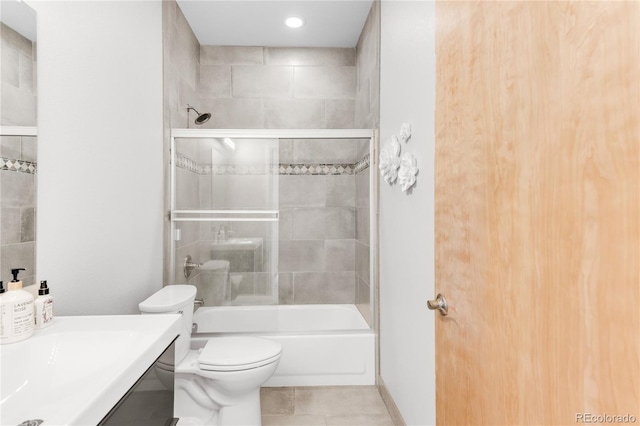 full bathroom with tiled shower / bath, vanity, toilet, and tile patterned flooring