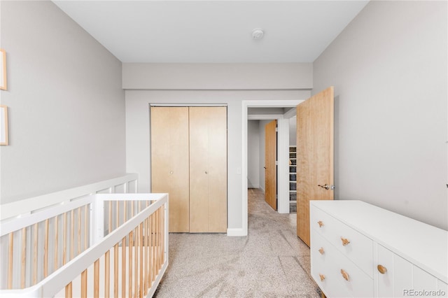 unfurnished bedroom with light colored carpet and a closet