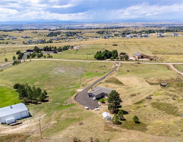 drone / aerial view featuring a mountain view and a rural view