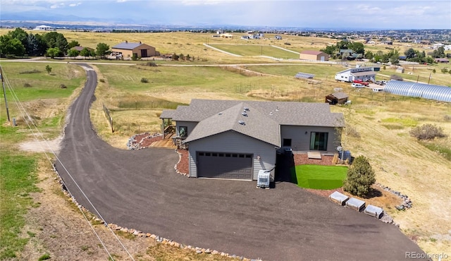 birds eye view of property with a rural view