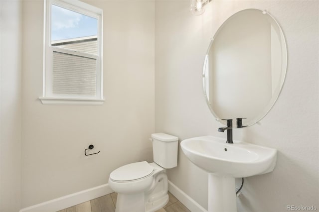 bathroom featuring hardwood / wood-style floors and toilet