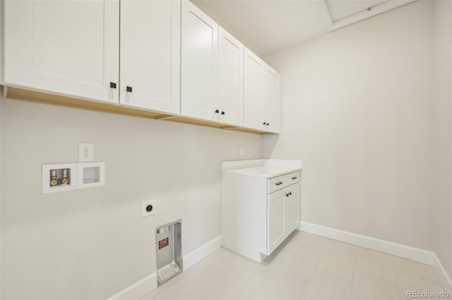 laundry room with washer hookup, electric dryer hookup, and cabinets