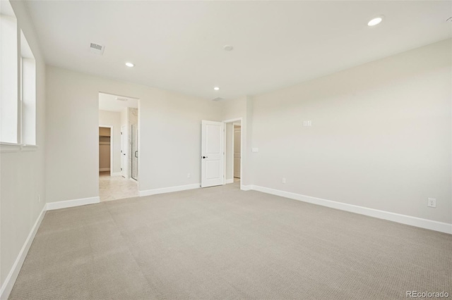 spare room featuring light colored carpet