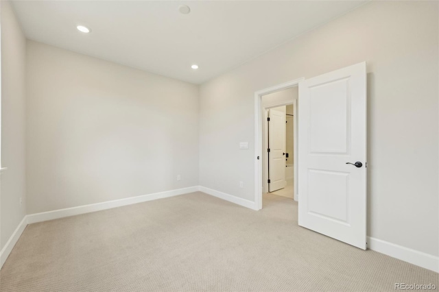 unfurnished room with light carpet