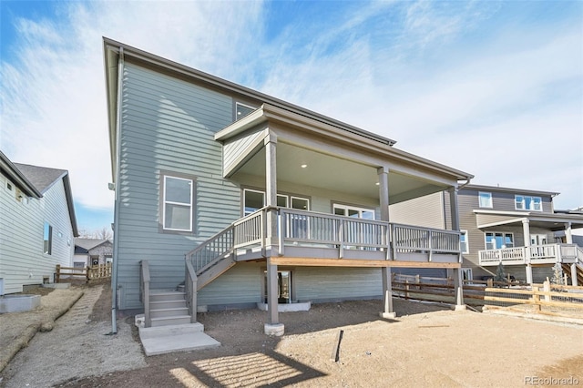 back of house with a wooden deck