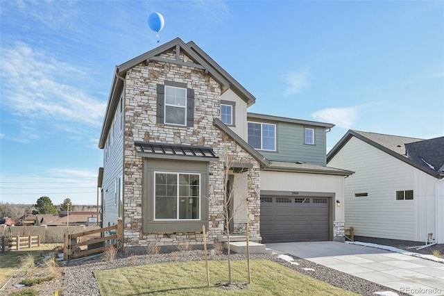 craftsman inspired home with a garage, driveway, stone siding, and fence