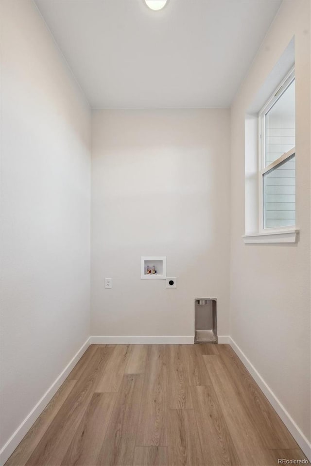 washroom with light wood-type flooring, hookup for a washing machine, and electric dryer hookup